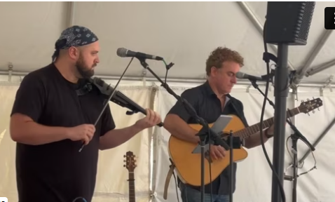 Photo  of Ian Gould with guitar and Lukas Jaeger with electric fiddle